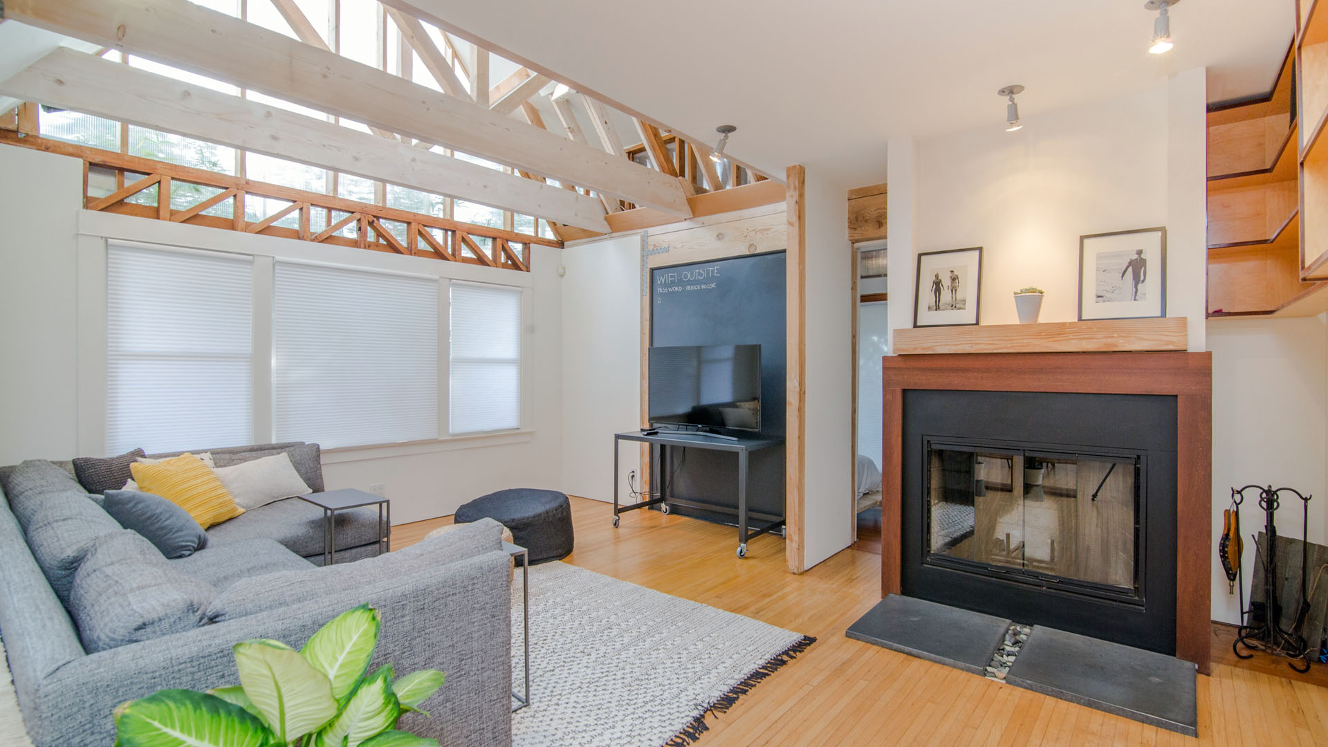 Naturally lit living area with natural wood wall units.
